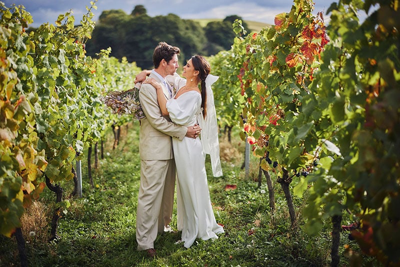 Vineyard Wedding Couple Embrace Vines