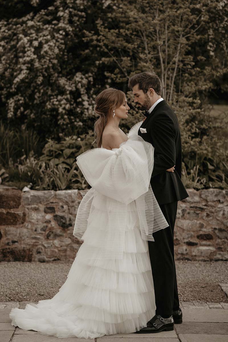 12-Bride-and-Groom-embrace-outside-of-Brickhouse-Vineyard-Devon