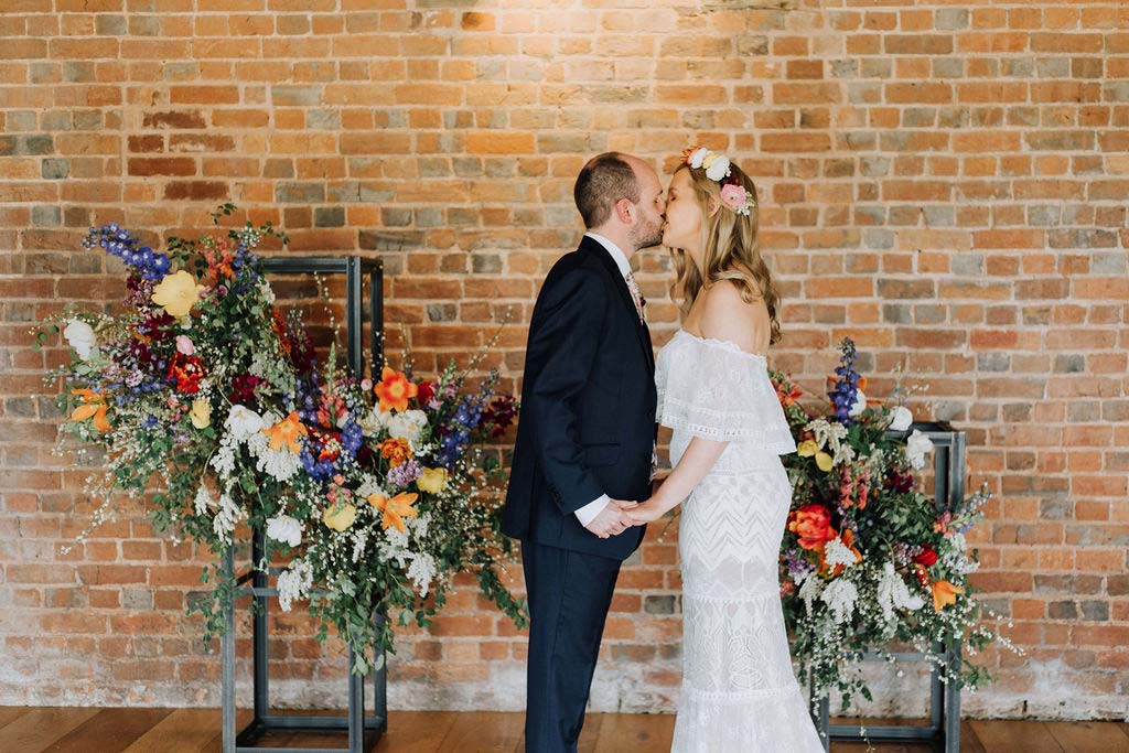 21-Wedding-couple-kiss-at-barn-venue-Devon