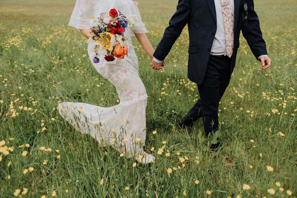 31-Elopement-couple-in-field-holding-hands