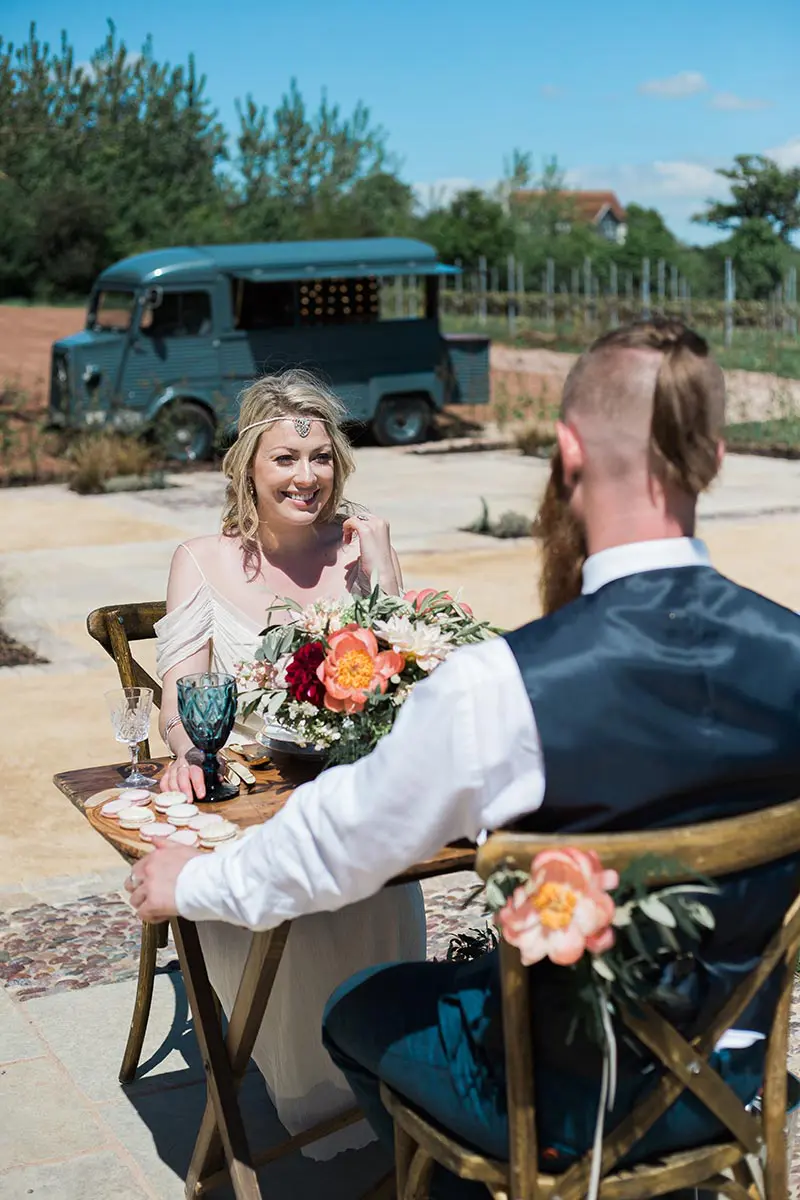 Bride and groom enjoying a drink and canapes on the terrace after their intimate wedding