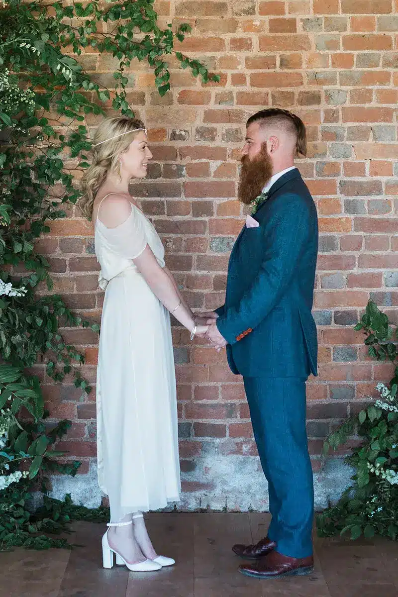 Bride and groom holding hands after their intimate wedding