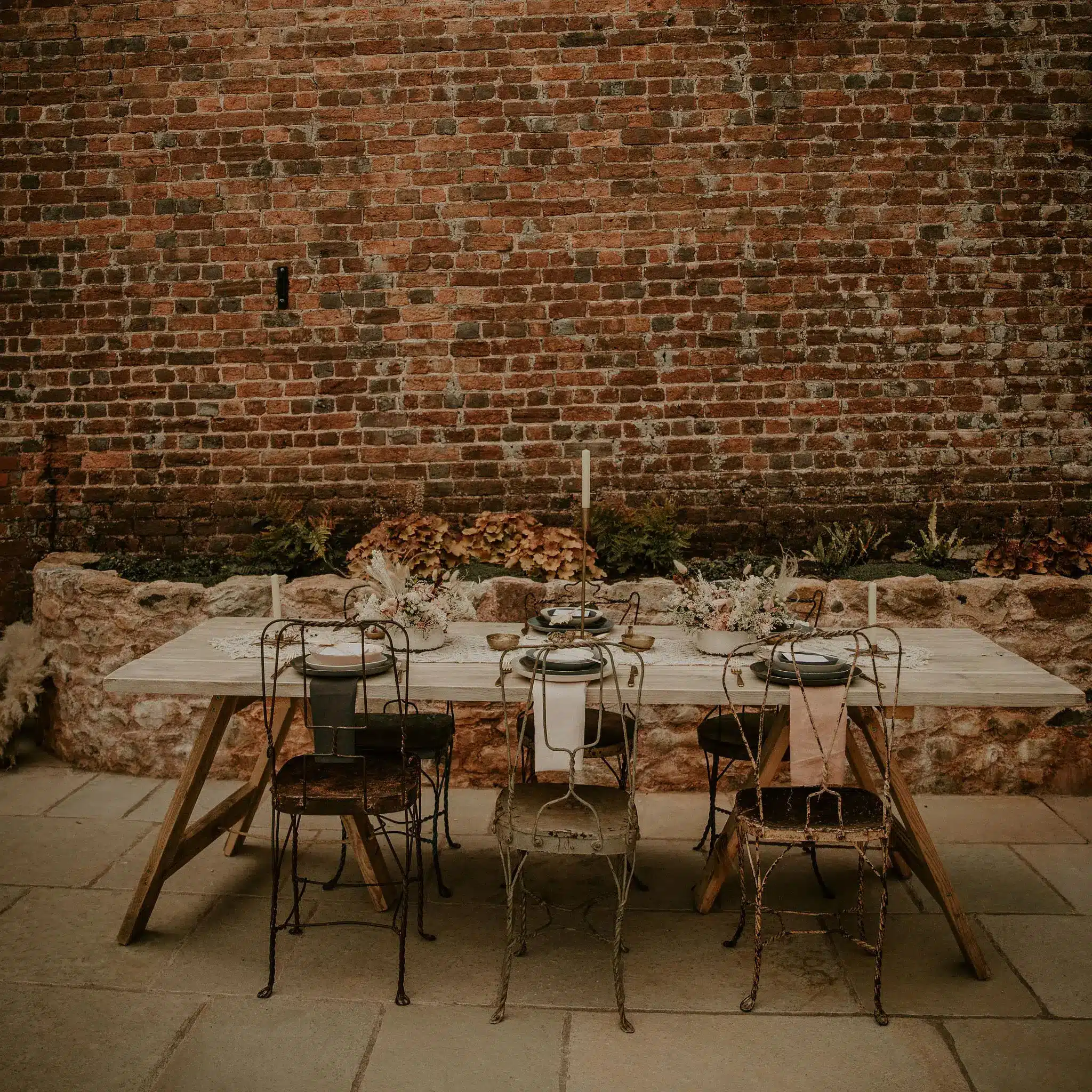 Same sex wedding venue table setting beside the barn