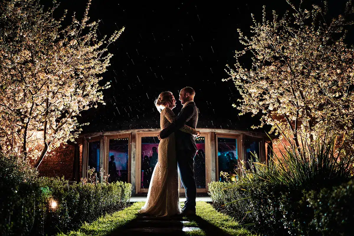 Married Couple Embrace At Small Wedding In Devon