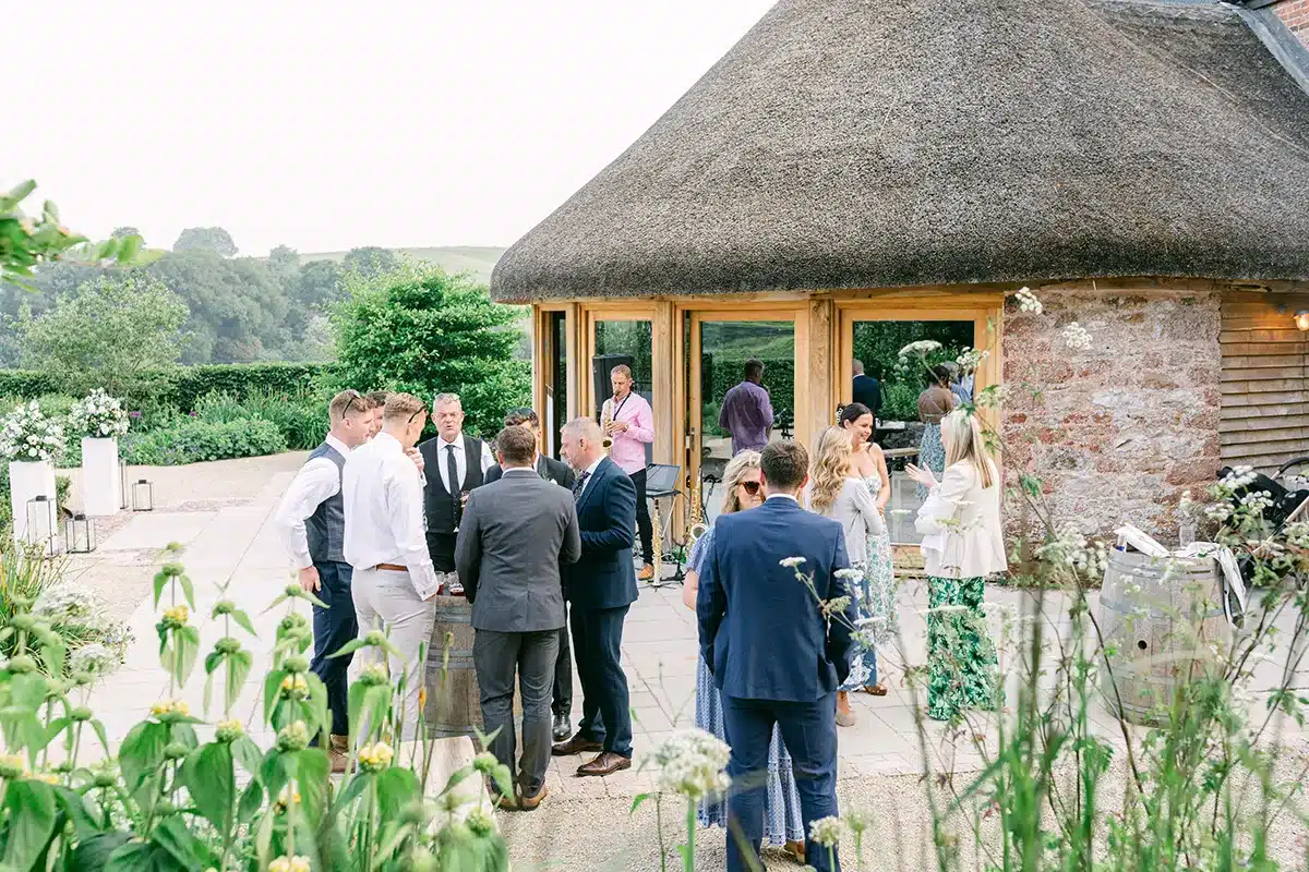 Guests Celebrating At Intimate Vineyard Wedding In Devon